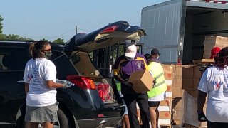 Hundreds turned out Saturday for a back-to-school community relief drive in Dallas offering school supplies, food, and personal-protective equipment kits.
