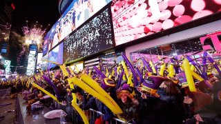 In this Dec. 31, 2019, file photo, revelers wait for the ball drop during New Year's Eve celebrations in Times Square in New York City.