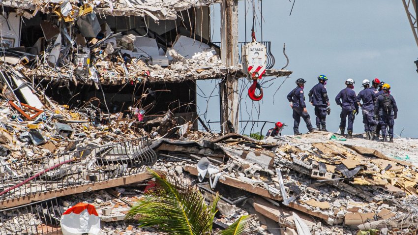 Search and Rescue teams look for possible survivors in the partially collapsed 12-story Champlain Towers South condo building on June 27, 2021 in Surfside, Florida.