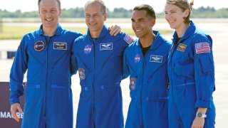 FILE - From left, European Space Agency astronaut Matthias Maurer of Germany, and NASA astronauts Tom Marshburn, Raja Chari, and Kayla Barron gather for a photo after arriving at the Kennedy Space Center in Cape Canaveral, Fla., on Tuesday, Oct. 26, 2021. A medical issue has sidelined one of four astronauts assigned to SpaceX’s upcoming flight to the International Space Station and delayed the launch, officials said Monday, Nov. 1, 2021.