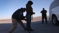 MESA, AZ – FEBRUARY 28:  A security contractor frisks a female immigration detainee from Honduras ahead of a deportation flight to San Pedro Sula, Honduras on February 28, 2013 in Mesa, Arizona. U.S. Immigration and Customs Enforcement (ICE), operates 4-5 flights per week from Mesa to Central America, deporting hundreds of undocumented immigrants detained in western states of the U.S. With the possibility of federal budget sequestration, ICE released 303 immigration detainees in the last week from detention centers throughout Arizona. More than 2,000 immigration detainees remain in ICE custody in the state. Most detainees typically remain in custody for several weeks before they are deported to their home country, while others remain for longer periods while their immigration cases work through the courts.  (Photo by John Moore/Getty Images)