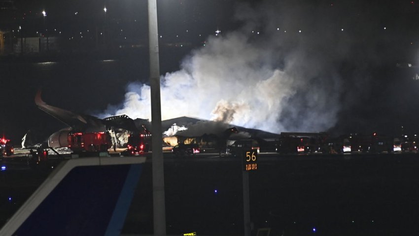 TOKYO, JAPAN – JANUARY 02: Smoke rises from burning plane after a Japan Airlines plane and an aircraft of Japan Coast Guard collided at Tokyo airport as firefighters intervene in the burning plane on January 02, 2024 in Tokyo, Japan. A collision between a Japan Airlines plane and an aircraft of Japan Coast Guard at a Tokyo airport left five crew members dead on Tuesday, police said. The coast guard plane was carrying aid for people affected by Monday’s earthquakes in the country. (Photo by David Mareuil/Anadolu via Getty Images)