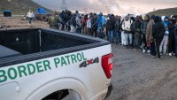 Asylum seekers wait in line to be processed by the Border Patrol at a makeshift camp near the US-Mexico border east of Jacumba, San Diego County, California, January 2, 2024. (Photo by Guillermo Arias / AFP) (Photo by GUILLERMO ARIAS/AFP via Getty Images)