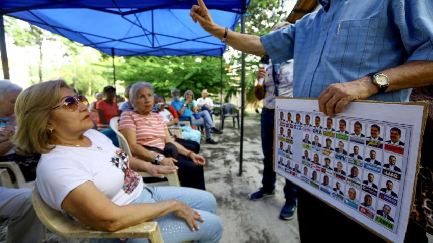 Supporters of Venezuelan Presidential candidate Edmundo Gonzalez attend a simulation exercise to learn how to vote in Valencia, Carabobo state, Venezuela on July 10, 2024. Venezuela will hold presidential elections on July 28. (Photo by Juan Carlos HERNANDEZ / AFP) (Photo by JUAN CARLOS HERNANDEZ/AFP via Getty Images)