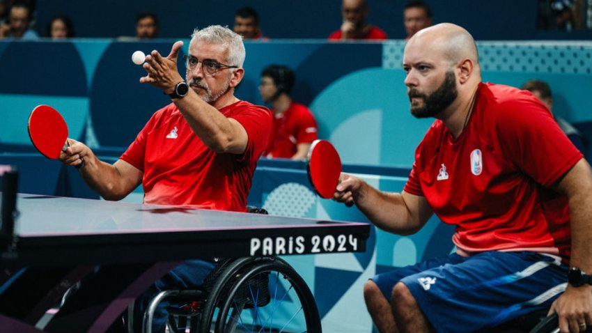 France’s Emeric Martin (L) serves a ball next to France’s Maxime Thomas during their men’s table tennis double match Round of 16 (class 4-3) between Slovakia and France at the Paris 2024 Paralympics Games at South Paris Arena in Paris, on August 29, 2024. (Photo by Dimitar DILKOFF / AFP) (Photo by DIMITAR DILKOFF/AFP via Getty Images)