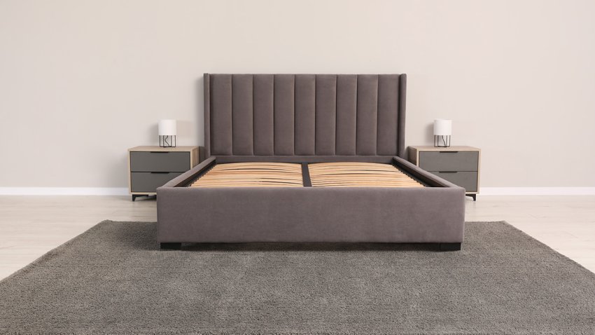 Comfortable bed with storage space for bedding under slatted base in room