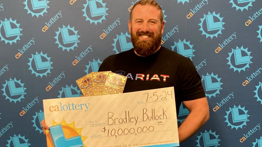 Scratch-ticket winner Bradley Bullock with his giant check from the California Lottery.