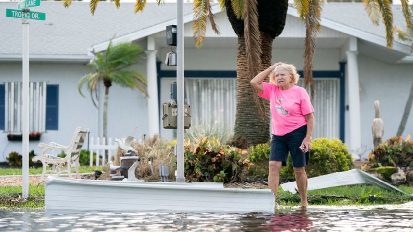 OSPREY, FLORIDA – OCTOBER 10: A woman walks along a flooded street in the aftermath of Hurricane Milton on October 10, 2024 in Osprey, Florida. The hurricane made landfall as a Category 3 hurricane in the Siesta Key area. (Photo by Sean Rayford/Getty Images)