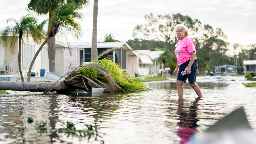 OSPREY, FLORIDA – OCTOBER 10: A woman walks along a flooded street in the aftermath of Hurricane Milton on October 10, 2024 in Osprey, Florida. The hurricane made landfall as a Category 3 hurricane in the Siesta Key area. (Photo by Sean Rayford/Getty Images)