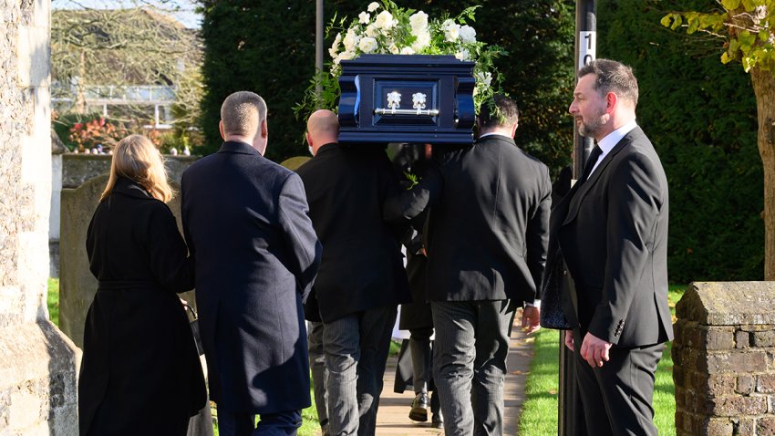 AMERSHAM, ENGLAND – NOVEMBER 20: Pallbearers carry the coffin of former member of One Direction singer Liam Payne at his funeral on November 20, 2024 in Amersham, England. Former One Direction star Liam Payne’s private funeral in Amersham has been widely anticipated to draw celebrities and fans alike, wishing to pay their final respects. The singer died after falling from a hotel balcony in Buenos Aires on October 16. (Photo by Karwai Tang/WireImage)