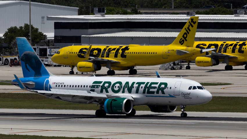 FORT LAUDERDALE, FLORIDA – MAY 16: A Frontier Airlines plane near a Spirit Airlines plane at the Fort Lauderdale-Hollywood International Airport on May 16, 2022 in Fort Lauderdale, Florida. JetBlue announced it is taking a hostile position in its effort to acquire Spirit Airlines. Spirit previously rejected a takeover offer from JetBlue, favoring an earlier deal to merge with Frontier airlines. (Photo by Joe Raedle/Getty Images)