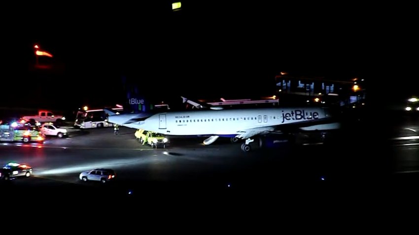 First responders surrounding a JetBlue plane at Boston's Logan International Airport during an incident Tuesday, Jan. 7, 2025.