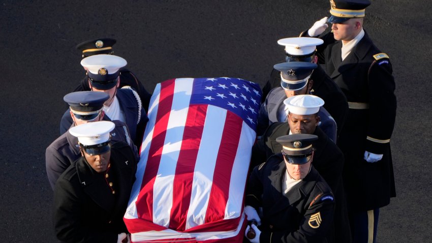 WASHINGTON, DC – JANUARY 7: The flag-draped casket of former President Jimmy Carter is transferred to a horse-drawn caisson at the U.S. Navy Memorial before traveling on to the Capitol in Washington, Tuesday, Jan. 7, 2025, where Carter will lie in state. Carter died Dec. 29 at the age of 100. (AP Photo/Mark Schiefelbein, Pool)