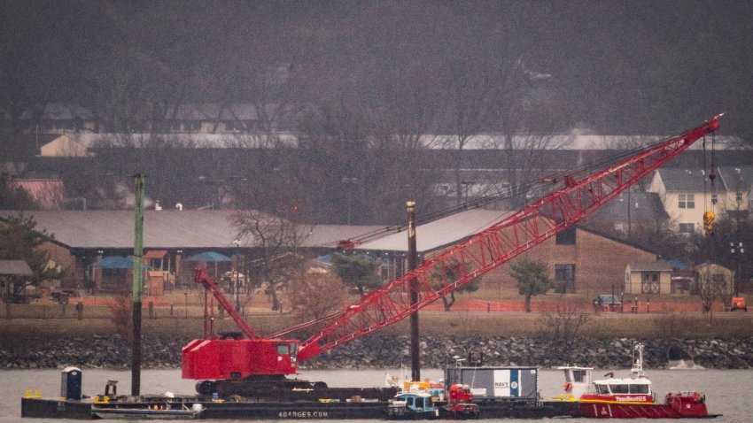 ARLINGTON, VIRGINIA – FEBRUARY 6: A crane floats on the Potomac River while removing wreckage from an American Airlines plane, on February 6, 2025 in Arlington, Virginia. An American Airlines flight from Wichita, Kansas collided midair with a military Black Hawk helicopter while on approach to Ronald Reagan Washington National Airport on January 29, 2025 outside of Washington, DC.(Photo by Al Drago/Getty Images)