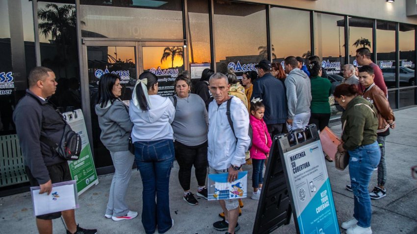 A group of recently arrived migrants including Cubans line up outside of the Children and Family offices in Hialeah, Florida, as a huge influx of migrants are arriving to Miami-Dade County after entering the U.S. through the Mexican border, on Feb. 14, 2024. (Pedro Portal/Miami Herald/Tribune News Service via Getty Images)