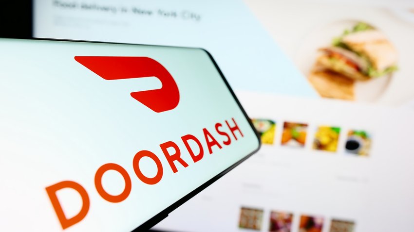Stuttgart, Germany – 07-25-2023: Mobile phone with logo of American food delivery company DoorDash Inc. on screen in front of website. Focus on center-right of phone display. Unmodified photo.