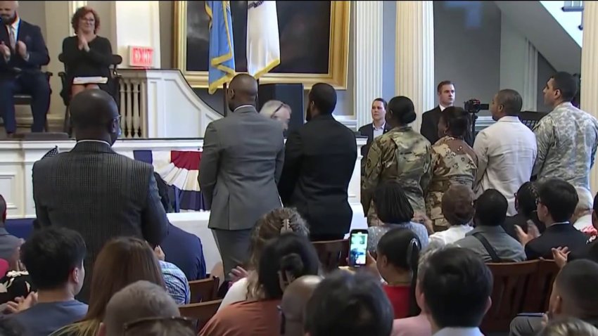 Immigrants attend a naturalization ceremony in Boston, Massachusetts.