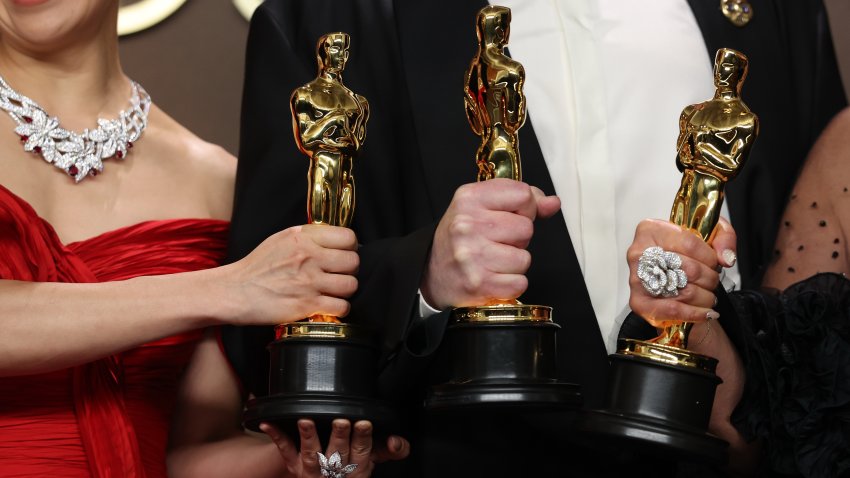 Maggie Kang, Chris Appelhans and Michelle L. M. Wong holding their Oscars
