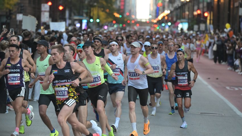 CHICAGO, ILLINOIS – OCTOBER 11: A pack of runners competes during the 48th Bank of America Chicago Marathon on Dearborn Street in the Loop, near the Alexander Calder’s Flamingo sculpture at Federal Plaza on October 11, 2026 in Chicago, Illinois. The 26.2-mile race started and finished in Grant Park, winding through 29 neighborhoods with over 55,000 participants. (Photo by Jacek Boczarski/Anadolu via Getty Images)